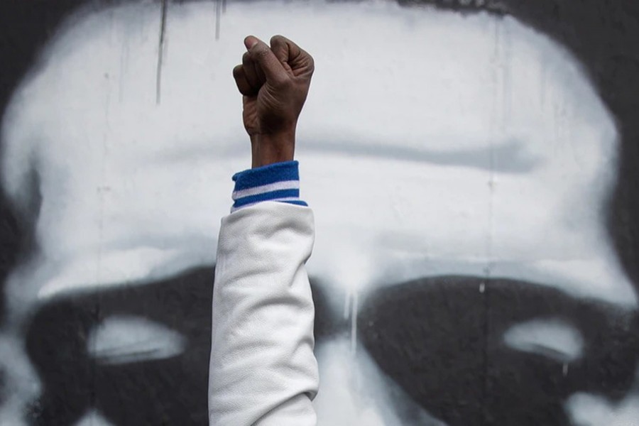 A Local resident raises his fist in front of an image of George Floyd after the verdict in the trial of former Minneapolis police officer Derek Chauvin, at George Floyd Square in Minneapolis, Minnesota on April 20, 2021 — Reuters photo