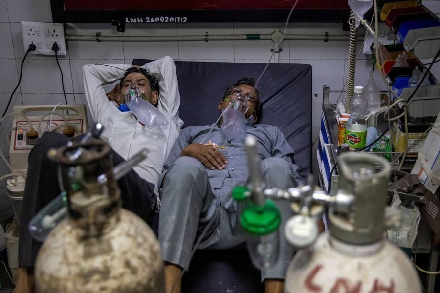 COVID-19 patients sharing a bed as they receive treatment at the casualty ward in Lok Nayak Jai Prakash (LNJP) hospital in New Delhi recently -Reuters file photo