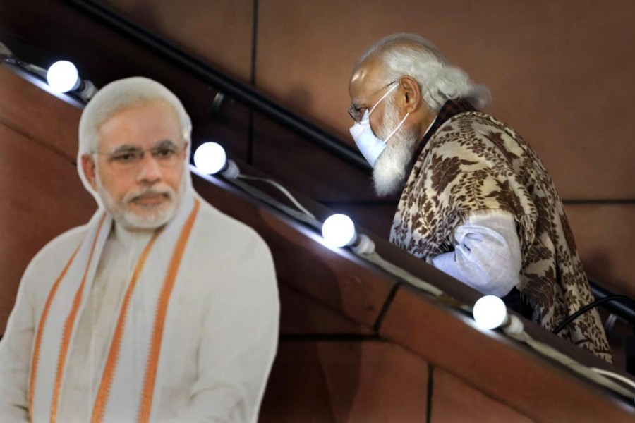 In this Nov. 11 2020, file photo, Indian Prime Minister Narendra Modi leaves after a function at the Bharatiya Janata Party headquarters following a state election in New Delhi, India. Despite clear signs that India was being swamped by another surge of coronavirus infections, Modi refused to cancel campaign rallies, a major Hindu festival and cricket matches with spectators - AP Photo/Manish Swarup, File