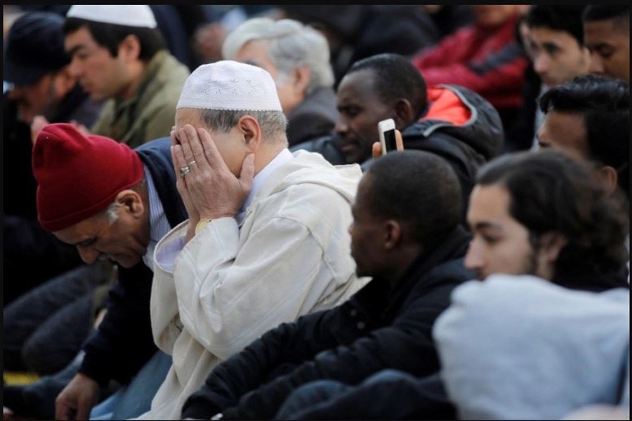Muslims pray during Friday prayers in the street in front of the city hall of Clichy, near Paris, France, April 21, 2017 (File: Benoit Tessier/Reuters)