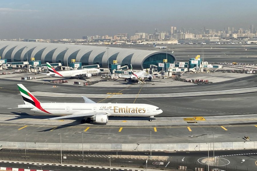 Emirates airliners are seen on the tarmac in a general view of Dubai International Airport in Dubai, United Arab Emirates January 13, 2021. Picture taken through a window. REUTERS/Abdel Hadi Ramahi
