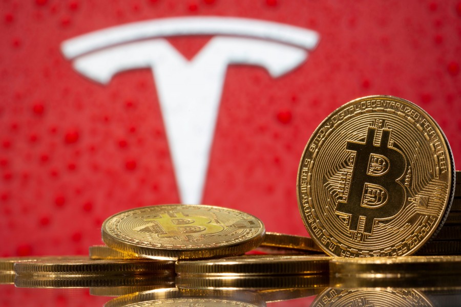 Representations of virtual currency Bitcoin are seen in front of Tesla logo in this illustration taken on February 9, 2021 — Reuters/Files