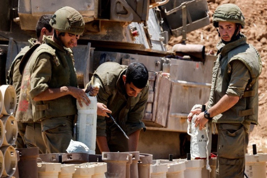 Israeli soldiers check artillery shells in an area near the border with Gaza, in southern Israel May 13, 2021 — Reuters