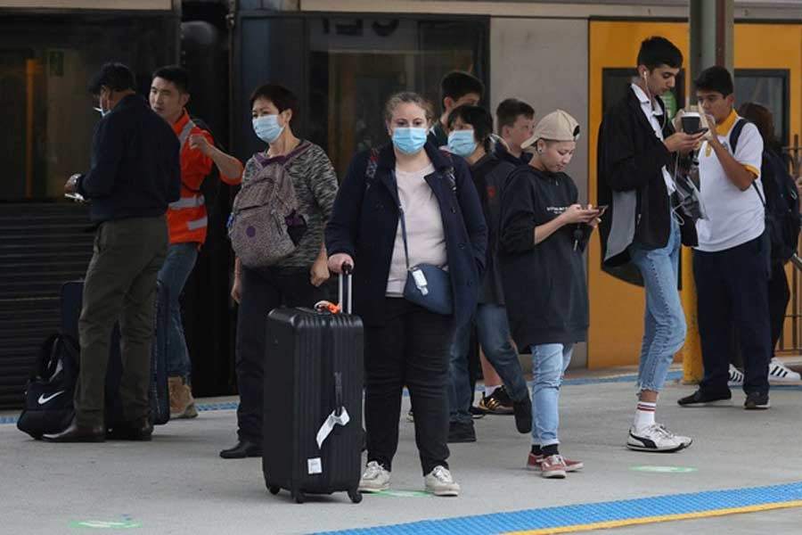 People, some wearing protective face masks, standing on a train platform at Central Station after new public health regulations were announced for greater Sydney, including compulsory mask-wearing on public transport, following the emergence of new cases of the coronavirus disease (COVID-19) in Sydney last week –Reuters file photo