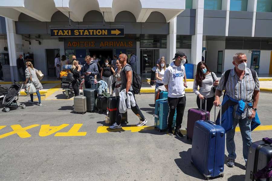 Passengers arriving from Germany and Switzerland standing with their luggage outside the terminal of the Heraklion airport, as the country's tourism season officially opens, on the island of Crete of Greece, on Saturday –Reuters photo