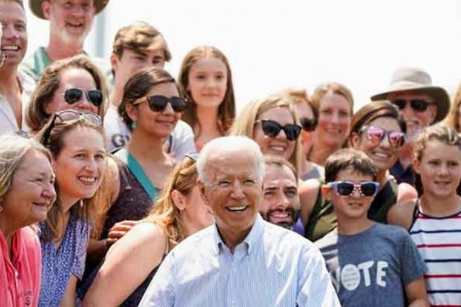 US President Joe Biden poses with supporters after touring King Orchards farm in Central Lake, Michigan, US, July 3, 2021. REUTERS/Joshua Roberts