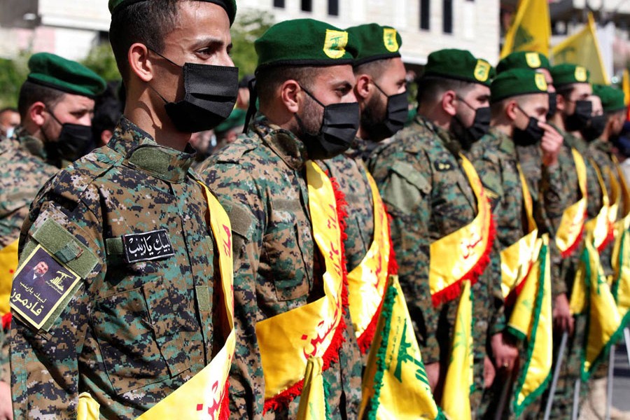 Hezbollah fighters attend the funeral procession of a comrade in Adloun, Lebanon, in May