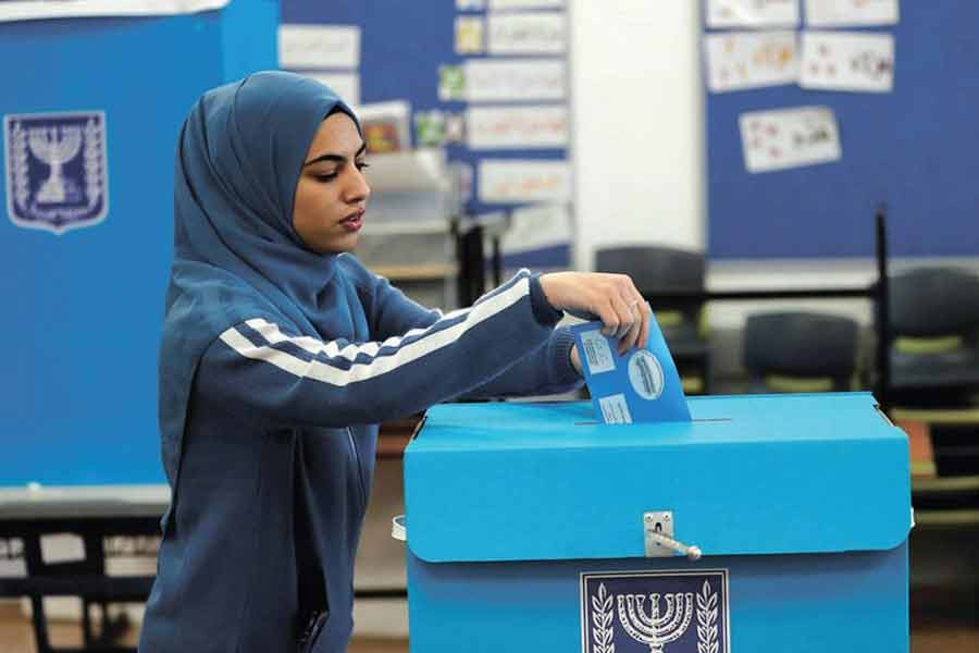 An Arab Israeli woman casts her ballot in the election at a polling station in Tamra, last March