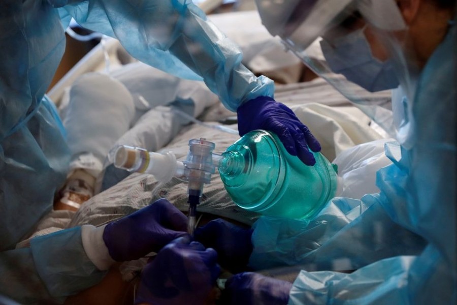 Critical care workers insert an endotracheal tube into a coronavirus disease (Covid-19) positive patient in the intensive care unit (ICU) at Sarasota Memorial Hospital in Sarasota, Florida on February 11, 2021 — Reuters/Files