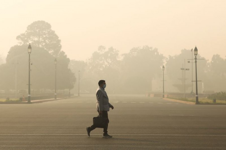 A man walks along a road on a smoggy morning in New Delhi, India on December 23, 2020 — Reuters/Files