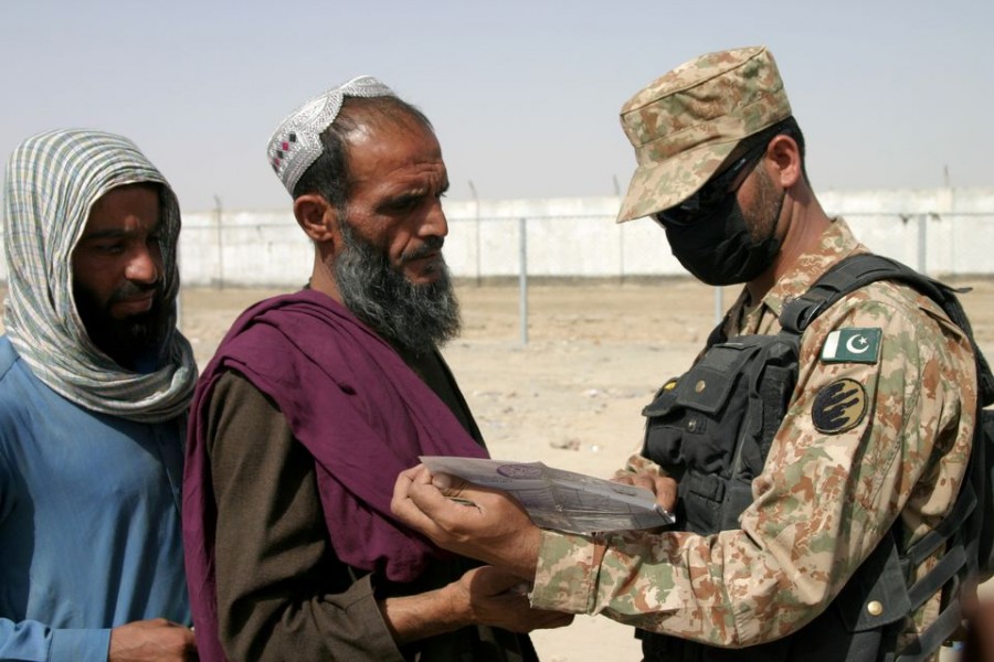 A Pakistani soldier checks documents of people arriving from Afghanistan at the Friendship Gate crossing point in the Pakistan-Afghanistan border town of Chaman, Pakistan on August 27, 2021 — Reuters photo