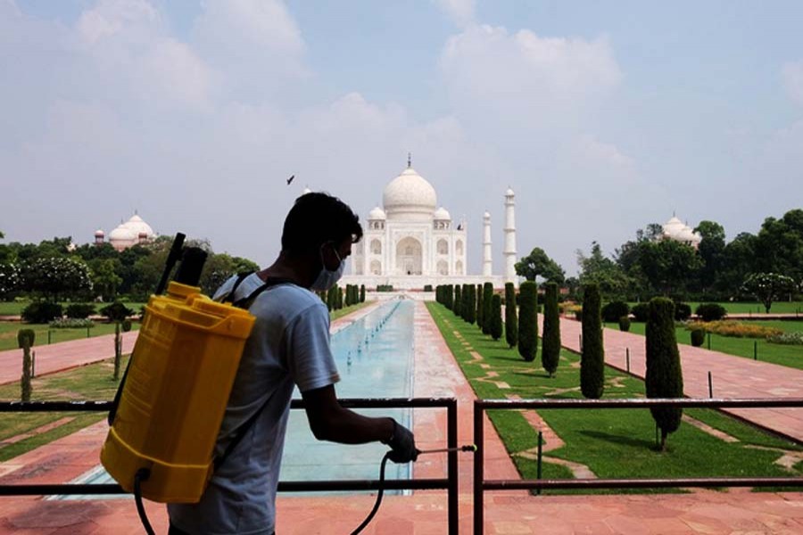 A man sanitises railings in the premises of Taj Mahal, in Agra, India, September 21, 2020. Reuters