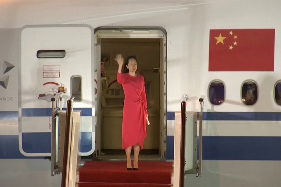 Huawei Technologies Chief Financial Officer Meng Wanzhou waves upon arriving from Canada at Shenzhen Baoan International Airport, in Shenzhen, Guangdong province, China September 25, 2021 — CCTV via Reuters