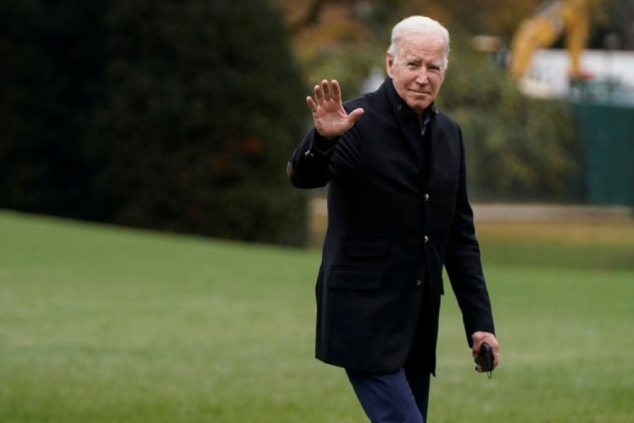 US President Joe Biden waves as he walks from Marine One as he arrives from Wilmington, Delaware, at the White House in Washington, US, Nov 21, 2021. REUTERS/Joshua Roberts