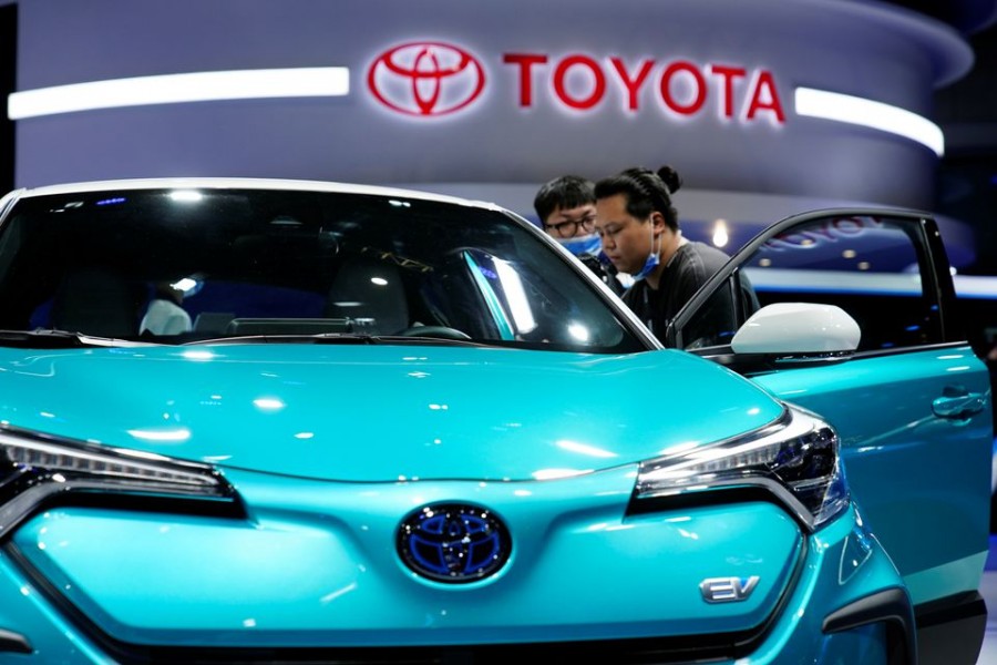 Visitors check a Toyota C-HR electric vehicle (EV) during a media day for the Auto Shanghai show in Shanghai, China April 19, 2021. REUTERS/Aly Song