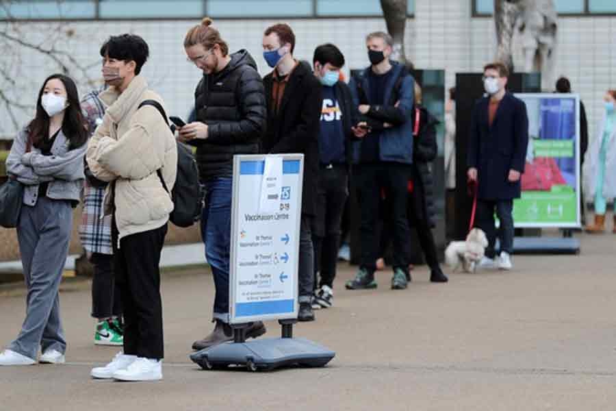 People waiting in a queue outside a coronavirus disease (COVID-19) vaccination centre at St Thomas' Hospital in London on Sunday –Reuters photo