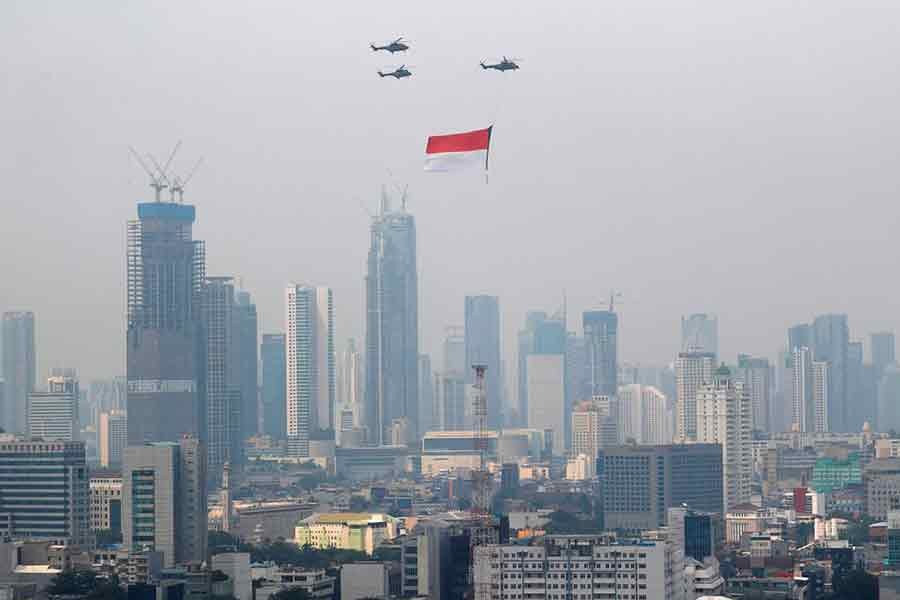 Indonesian Air Force helicopters carrying a big flag fly above high rise buildings in Jakarta during the country's 76th Independence Day celebrations on August 17 last year –Reuters file photo