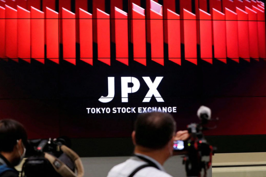 TV camera men wait for the opening of market in front of a large screen showing stock prices at the Tokyo Stock Exchange in Tokyo, Japan October 2, 2020. REUTERS/Kim Kyung-Hoon