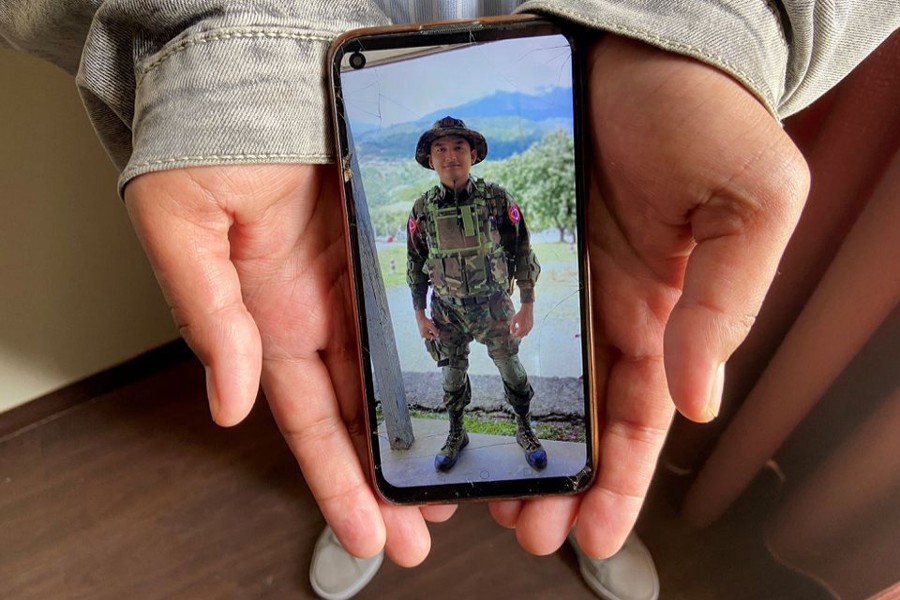 Kaung Thu Win, who said he served as a captain in Myanmar's military before defecting in late December, shows a photograph of himself wearing an army uniform on his mobile phone, during an interview with Reuters at an undisclosed location in northeastern India on January 21, 2022 — Reuters/Files