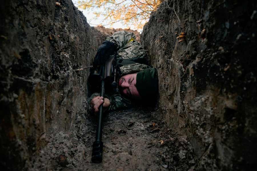 A Ukrainian soldier hiding from a helicopter airstrike near Demydiv of Ukraine on Thursday amid Russia's invasion of Ukraine –Reuters photo