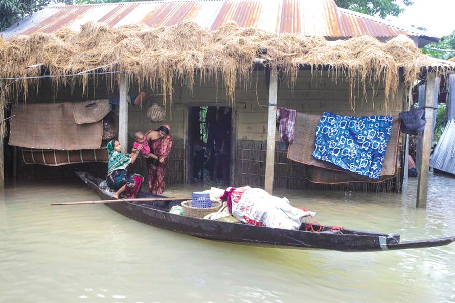 People prepare to move by boat from a flood-affected area to a safe place in Sylhet, Bangladesh, on June 19, 2022.	—Xinhua Photo