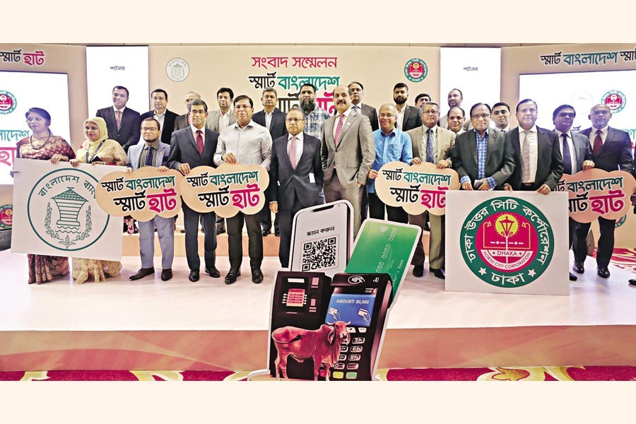 LGRD and Cooperatives Minister Md Tajul Islam and Dhaka North City Corporation (DNCC) Mayor Atiqul Islam pose for photograph after they jointly inaugurated digital banking activities for the DNCC cattle markets at a city hotel on Wednesday — Focus Bangla