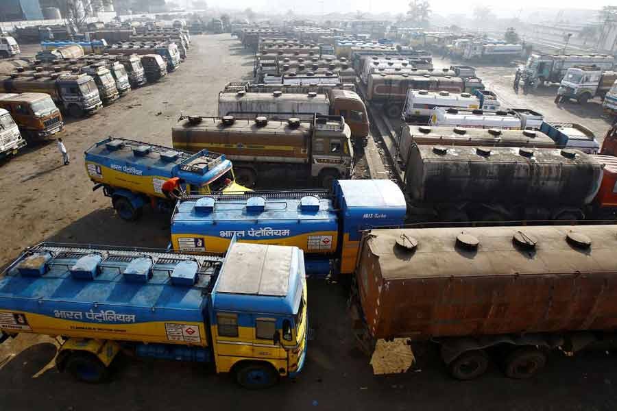 Oil tankers are seen parked at a yard outside a fuel depot on the outskirts of Kolkata in India –Reuters file photo