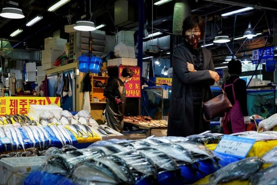 A woman wearing a protective mask is seen at a fish market amid the coronavirus disease (COVID-19) outbreak continues in Seoul, South Korea April 5, 2020 REUTERS