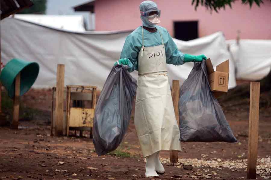 A health worker carrying waste for disposal outside the isolation ward where victims of the deadly Marburg virus are treated in a northern Angolan town –Reuters file photo