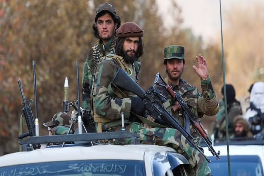 Members of Taliban sit on a military vehicle during Taliban military parade in Kabul, Afghanistan Nov 14, 2021. REUTERS