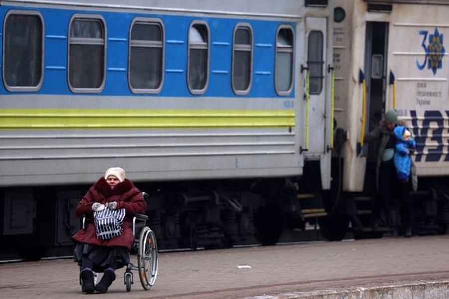 A person in a wheelchair waits for transfer after fleeing the ongoing Russian invasion at the main train station in Lviv, Ukraine, Mar 5, 2022. |REUTERS