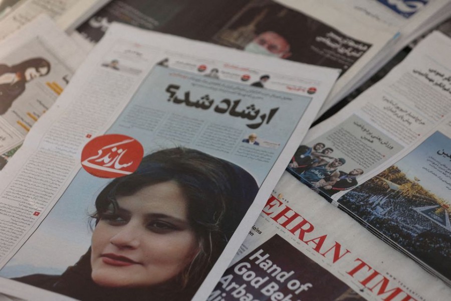 A newspaper with a cover picture of Mahsa Amini, a woman who died after being arrested by Iranian morality police is seen in Tehran, Iran, September 18, 2022. Majid Asgaripour/WANA (West Asia News Agency) via REUTERS