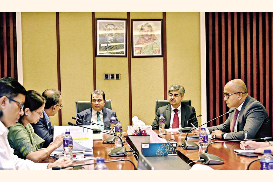 Finance Minister AHM Mustafa Kamal and representatives of the International Monetary Fund (IMF) at a meeting in Dhaka on Wednesday — PID