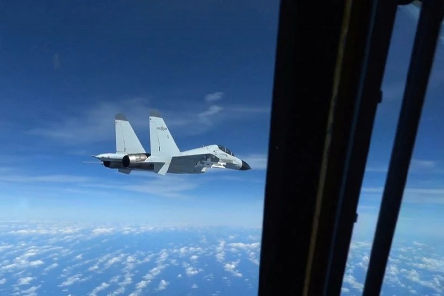 A Chinese Navy J-11 fighter jet is recorded flying close to a US Air Force RC-135 aircraft in international airspace over the South China Sea, according to the US military, in a still image from video taken on December 21, 2022 — US Indo-Pacific Command/Handout via REUTERS