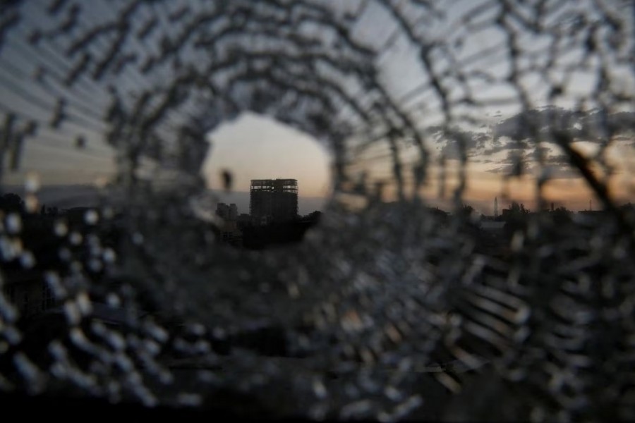 A building is seen through a bullet hole in a window of the Africa Hotel in the town of Shire, Tigray region, Ethiopia, March 16, 2021. REUTERS/Baz Ratner/File Photo