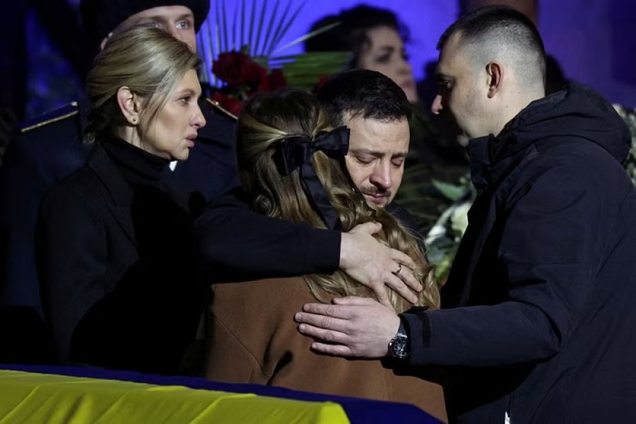 Ukraine's President Volodymyr Zelensky and first lady Olena Zelenska offer their condolences as they attend a memorial ceremony for Ukrainian Interior Minister Denys Monastyrskyi, his deputy and officials who died in the helicopter crash near Kyiv, in Kyiv, Ukraine, January 21, 2023. REUTERS