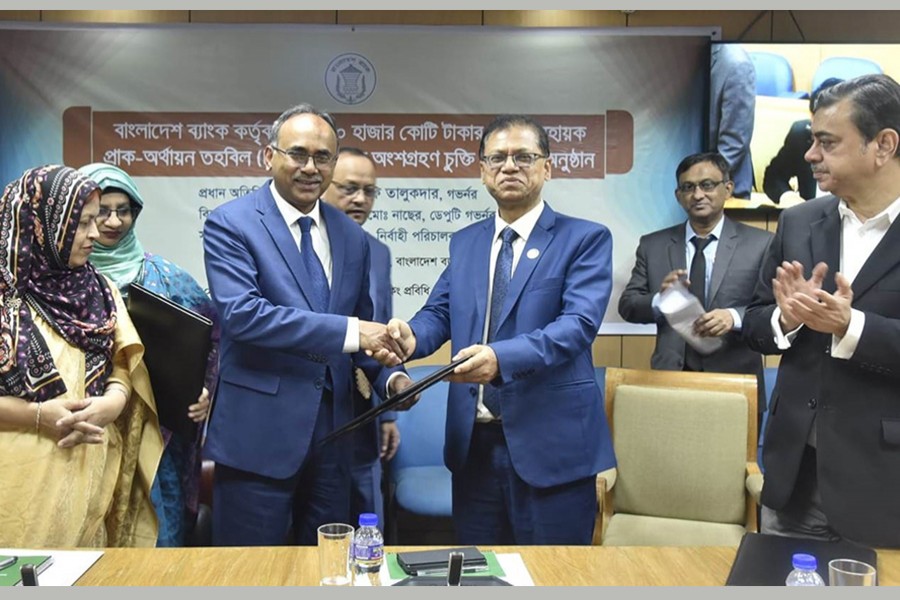 Sonali Bank Limited CEO and Managing Director Md Afzal Karim seen handing over the signed contract to Bangladesh Bank governor Abdur Rouf Talukder